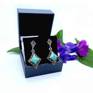 925 Silver and Marcasite earrings in box with flower background