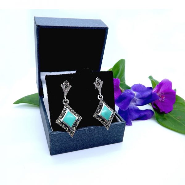 925 Silver and Marcasite earrings in box with flower background
