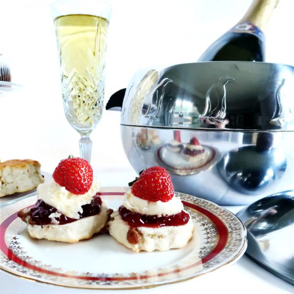 Vintage Penguin Ice Bucket with cream tea and bottle of champagne in the ice bucket