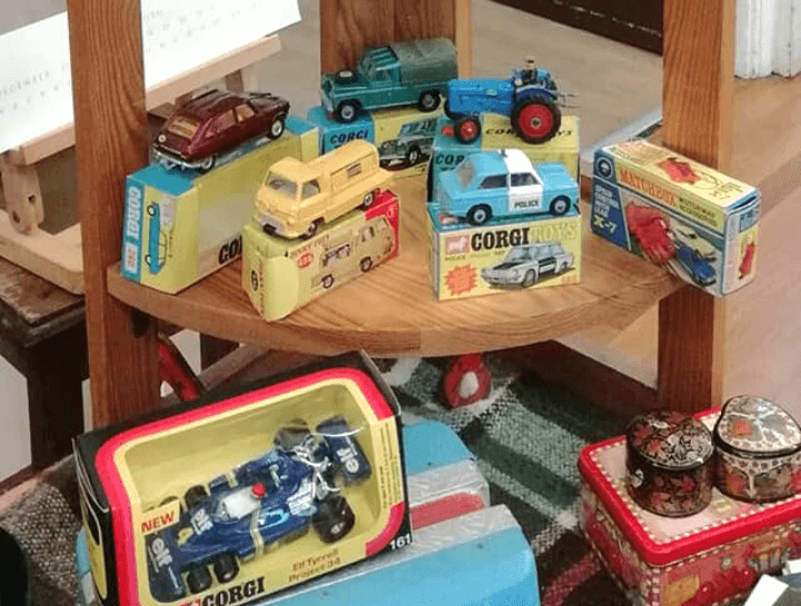 corgi cars and other collectable toys on a display stand at flitwick antiques and collectors fair