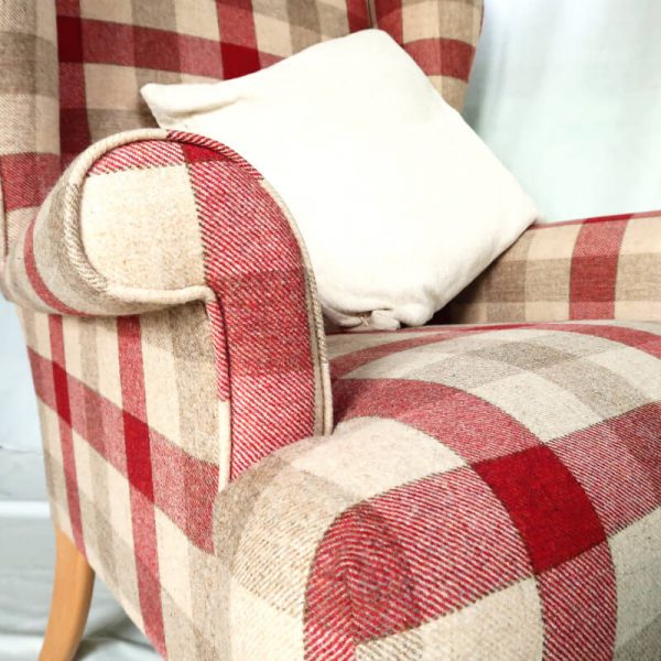 Wing back chair vintage style close up view of red and beige check chair fabric