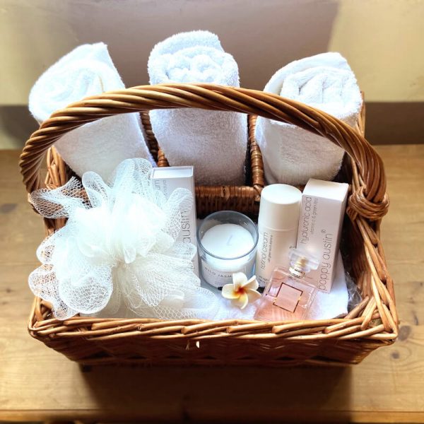 Wicker Basket filled with toiletries towels and beauty products