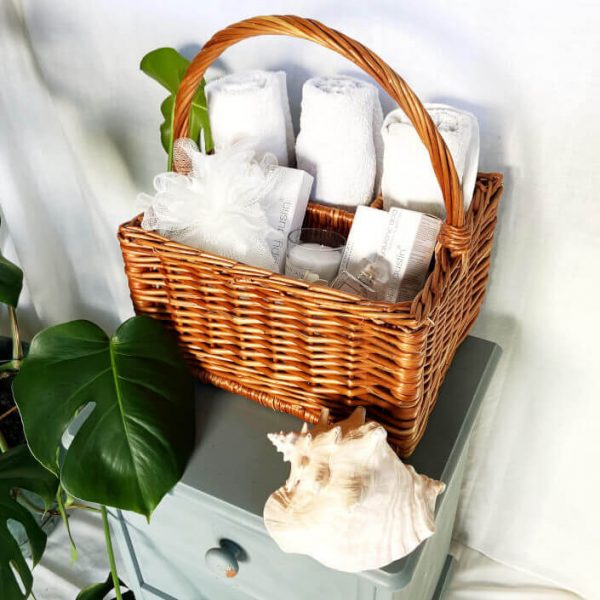 Wicker Basket on bathroom side filled with beauty products